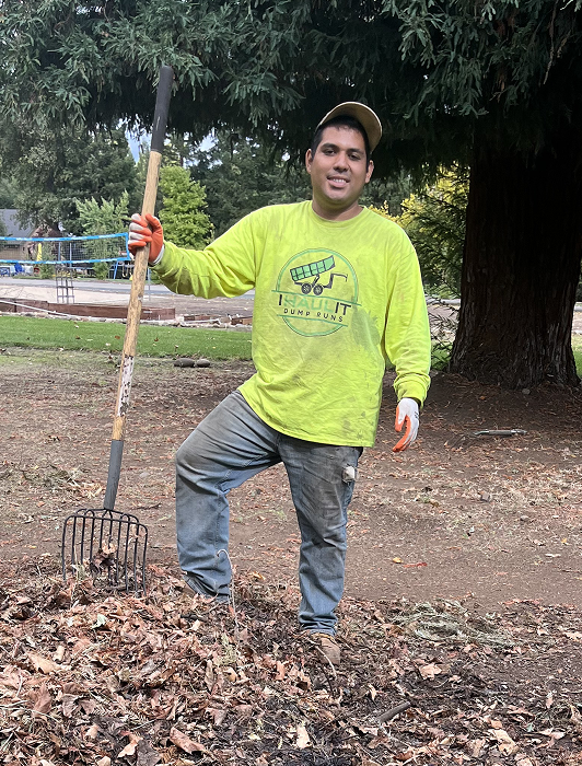 Cristian Garcia, owner of Ihaulit Dump Runs, clearing yard debris